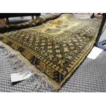 A gold Afghan carpet with motifs on mustard ground with multi border 190 x 155cm