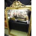 A large wall mirror with an ornate gilt frame.