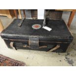 A vintage/early 20th leather and black canvas trunk by cane with target motif and brown leather