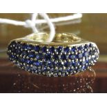 An 18ct yellow gold dress ring set blue sapphire chips