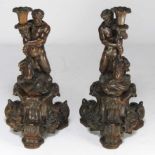 PAIR OF ITALIAN CARVED FIGURAL CANDLE HOLDERS 19th c., each a merman kneeling on rocks, holding a