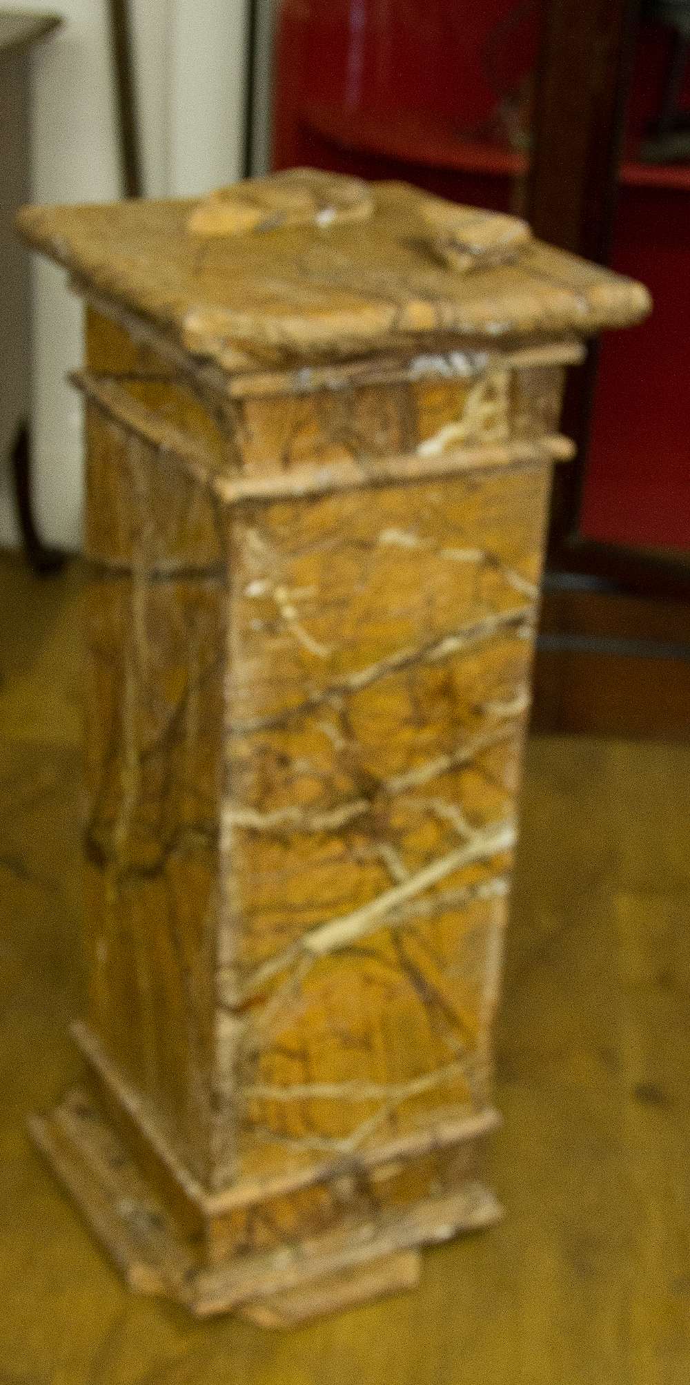 A COMPOSITION STONE PLINTH, in the form of a square pillar with marbled finish, W 100 cm, A/F