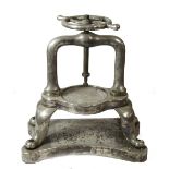 AN EARLY 20TH CENTURY SILVER PLATED DUCK PRESS, raised on four legs terminating on a shaped base