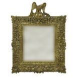 A LARGE GILT WOOD WALL MIRROR IN THE REGENCY STYLE, the elaborate frame with a floral scrolling