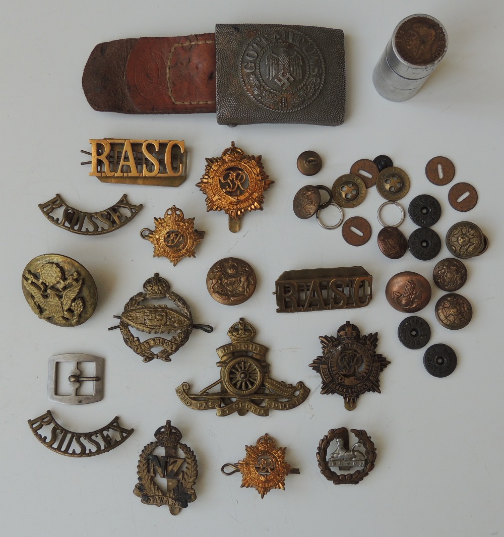 A COLLECTION OF MILITARY BADGES AND INSIGNIA, to include a German Third Reich military buckle,