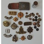 A COLLECTION OF MILITARY BADGES AND INSIGNIA, to include a German Third Reich military buckle,