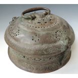 AN ANTIQUE MIDDLE EASTERN COPPER ALLOY BRAZIER, of circular form with domed lid, bands of floral