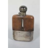 A SILVER MOUNTED AND LEATHER COVERED HIP FLASK, hallmarked Sheffield 1927, H 15 cm Buyers - for