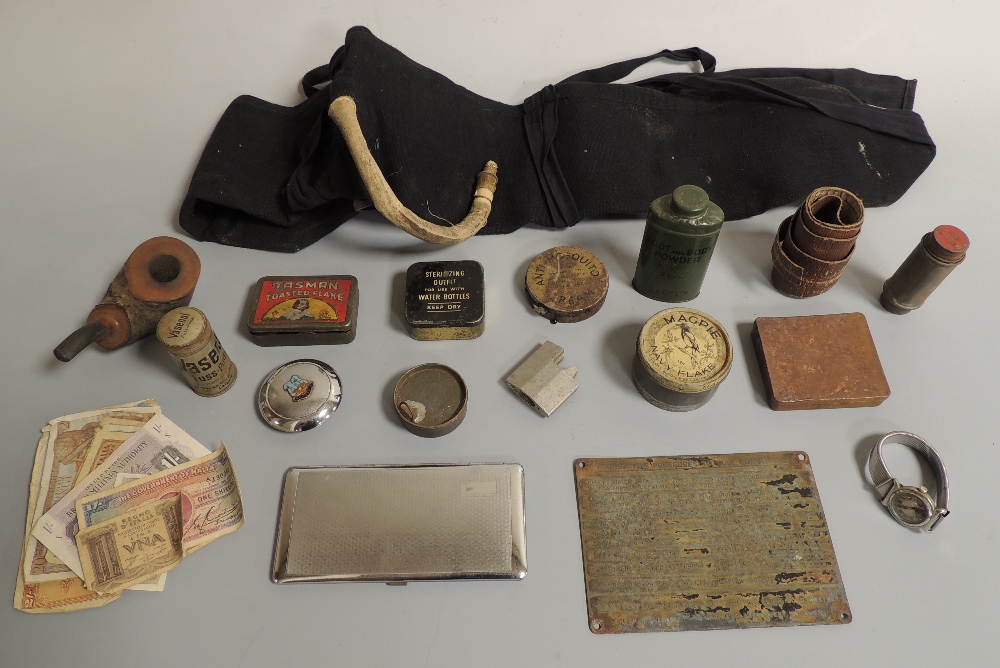 A TRAY OF MAINLY MILITARY INTEREST COLLECTABLES, to include tins, banknotes, wrist watch etc. Buyers