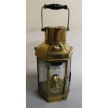 A BRASS SHIP'S LAMP, with canted sides and swing handle, marked 'Eli Griffiths & Sons 1915', H 40 cm