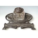 A LATE VICTORIAN BRONZED IRON INK STAND, marked 'RD 505078 No 7', fitted with a single pressed glass