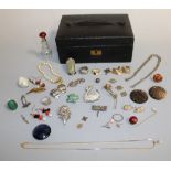 A LEATHER JEWELLERY BOX AND CONTENTS, to include costume jewellery, belt clips, scent bottle, rings,