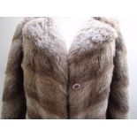 A LADIES FULL LENGTH RETRO STYLE VINTAGE FUR COAT, the fur styled in diagonal panels to the front