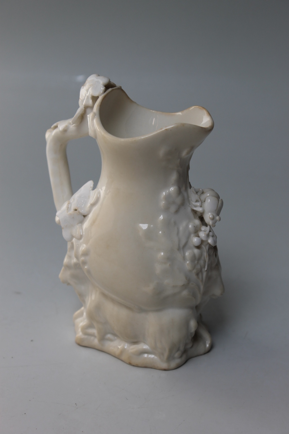 A 19TH CENTURY BLANC DE CHINE SMALL JUG, possibly Coalport, modelled with two mountain goats to - Image 2 of 4