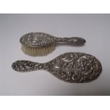 A SILVER BACKED HAND MIRROR - BIRMINGHAM 1901, together with a silver backed child's hairbrush, both