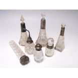 A COLLECTION OF SILVER TOPPED VANITY AND PERFUME BOTTLES, various dates and makers, to include a