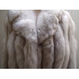 A VINTAGE SILVER FOX FUR JACKET, contrasting leather panels alternate with the fur, giving scalloped