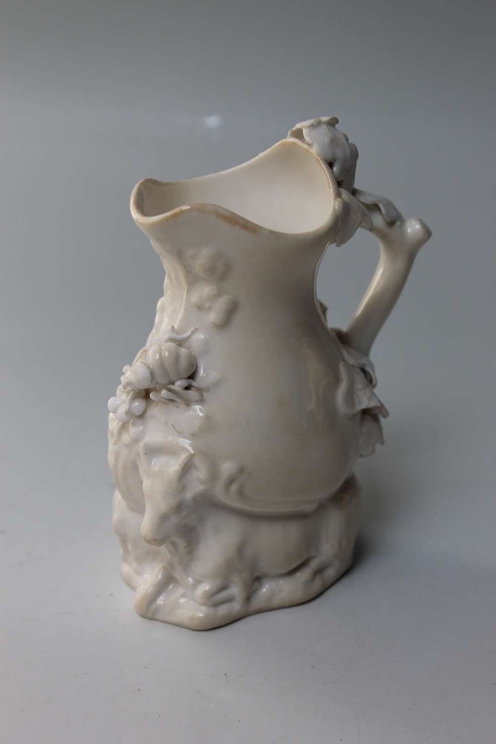A 19TH CENTURY BLANC DE CHINE SMALL JUG, possibly Coalport, modelled with two mountain goats to