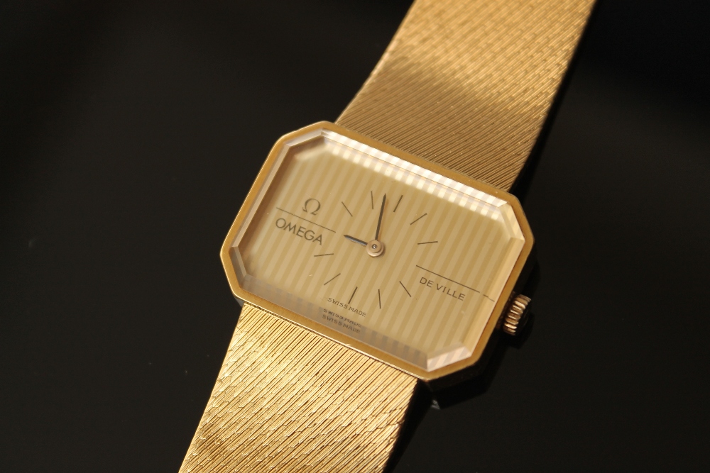 OMEGA - A RARE 18 CARAT GOLD DEVILLE WRISTWATCH, having stripped two tone gold dial, hour baton