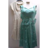 A 1950S 'BLANES' GREEN SATIN DRESS, with metallic thread embellishment an ornate diamante buckle,