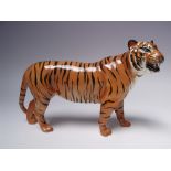 A BESWICK CERAMIC MODEL OF A TIGER - 2096, oval Beswick stamp to both front paws, L 30 cm Buyers -