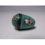 AN 18TH CENTURY ENGLISH ENAMEL EGG SHAPED NUTMEG GRATER, with floral decoration on a green ground,