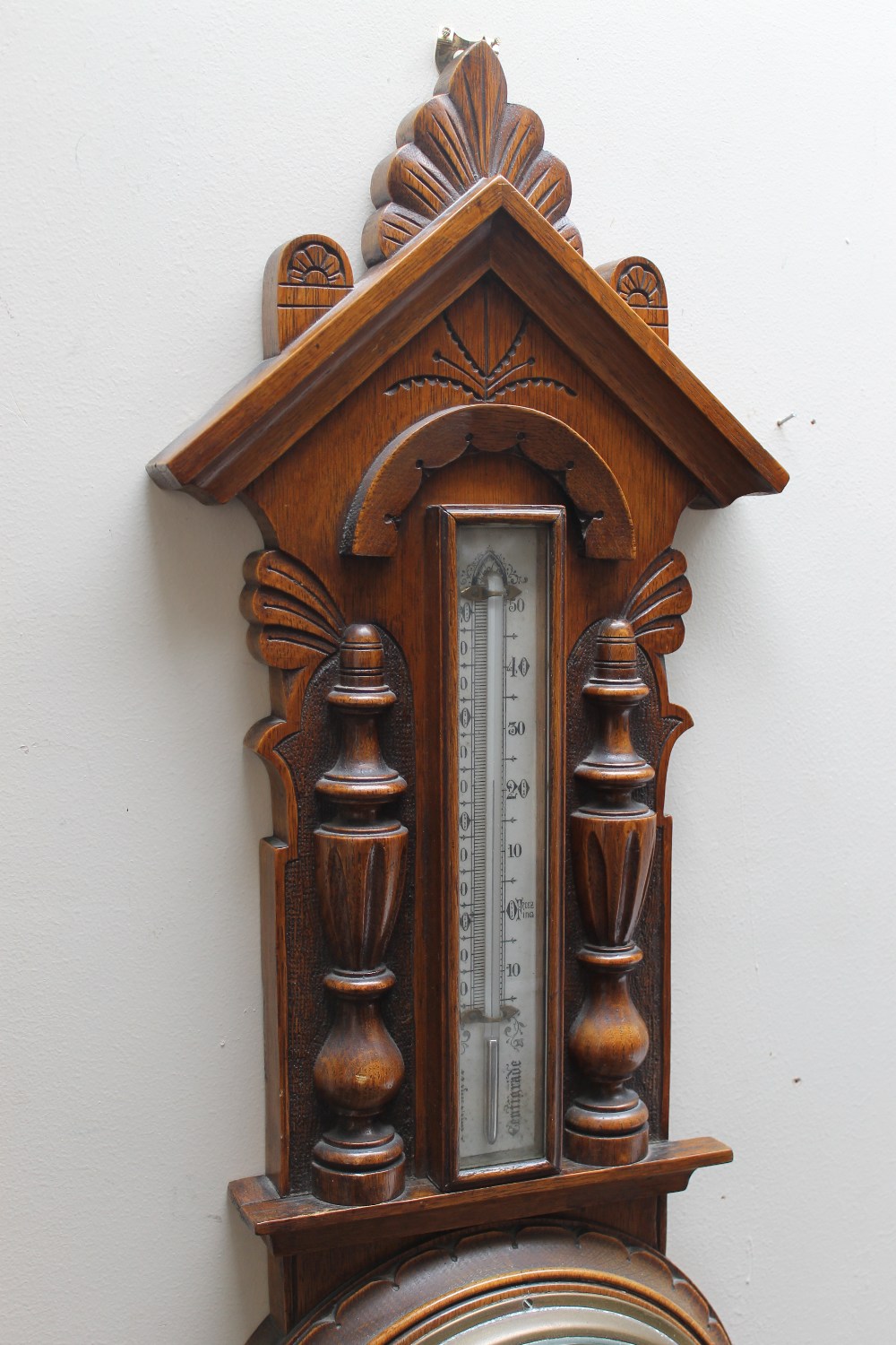 AN EARLY 20TH CENTURY OAK CARVED ANEROID BAROMETER, of Gothic style, carved with half turned - Image 3 of 3