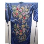 A DARK BLUE JAPANESE SILK KIMONO, with elaborate embroidered floral decoration to the reverse, and