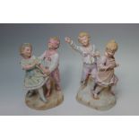 TWO 19TH CENTURY TINTED BISQUE FIGURE GROUPS OF PLAYING CHILDREN, the one of a boy and girl