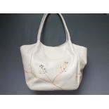 A GENUINE LADIES RADLEY LEATHER HANDBAG, the main body in cream with embroidered floral decoration