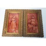 A PAIR OF FRAMED VICTORIAN MAJOLICA PANELS, decorated in brown relief with farmer's wives feeding