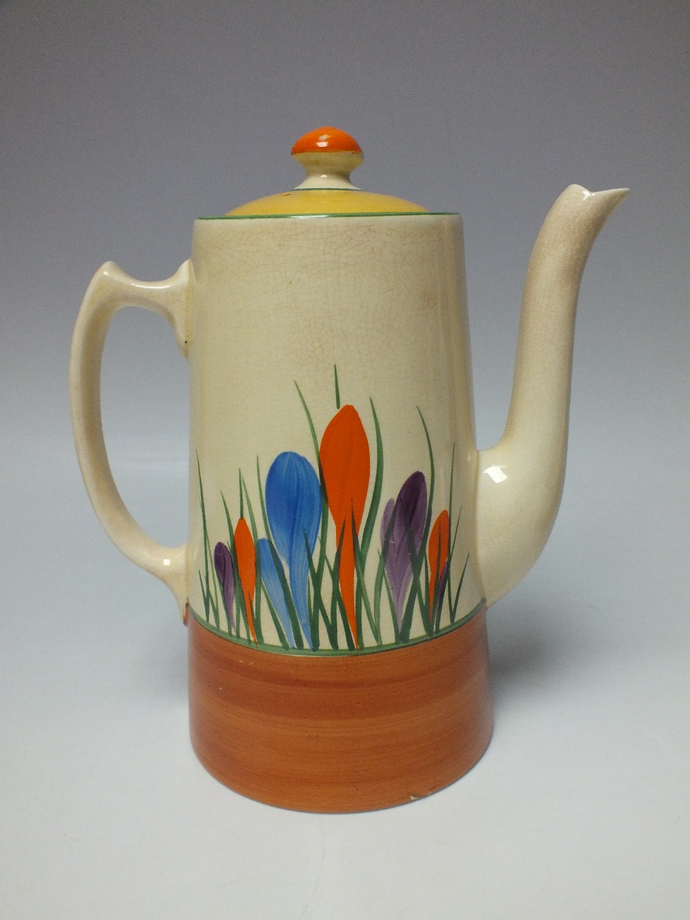 A CLARICE CLIFF 'CROCUS PATTERN' COFFEE POT, cream ground with hand painted decoration, painted