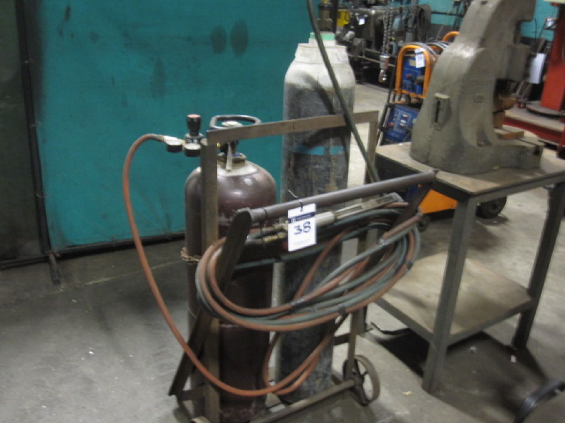 Oxy/acetylene gas cutting torch with tubing and regulators complete with bottle trolley.  Note: