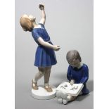 Zwei Skulpturen, Bing & Gröndahl.Tanzendes Mädchen und sitzendes Mädchen mit Bilderbuch. Bunte