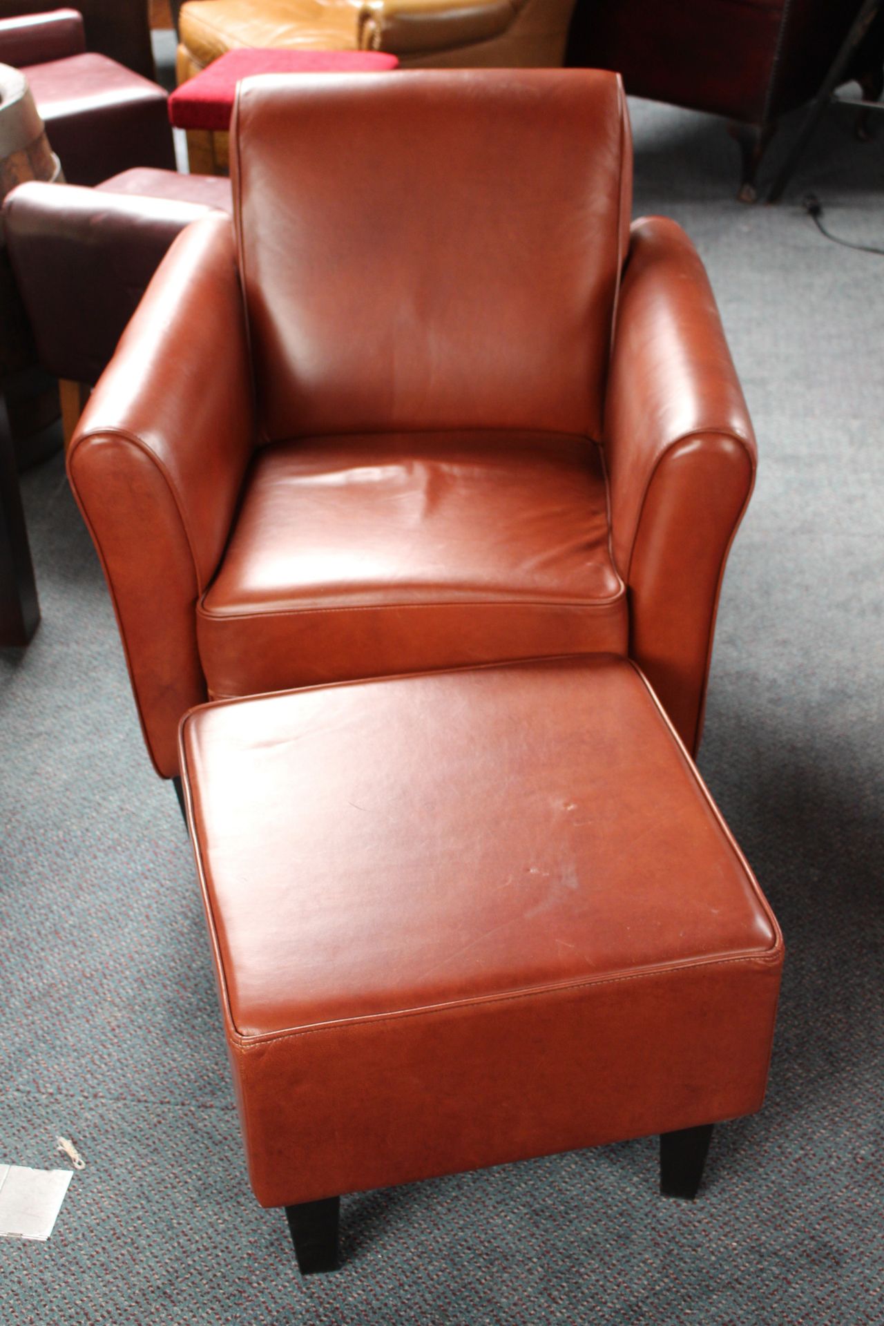 Brown leather gentleman armchair with foot stool