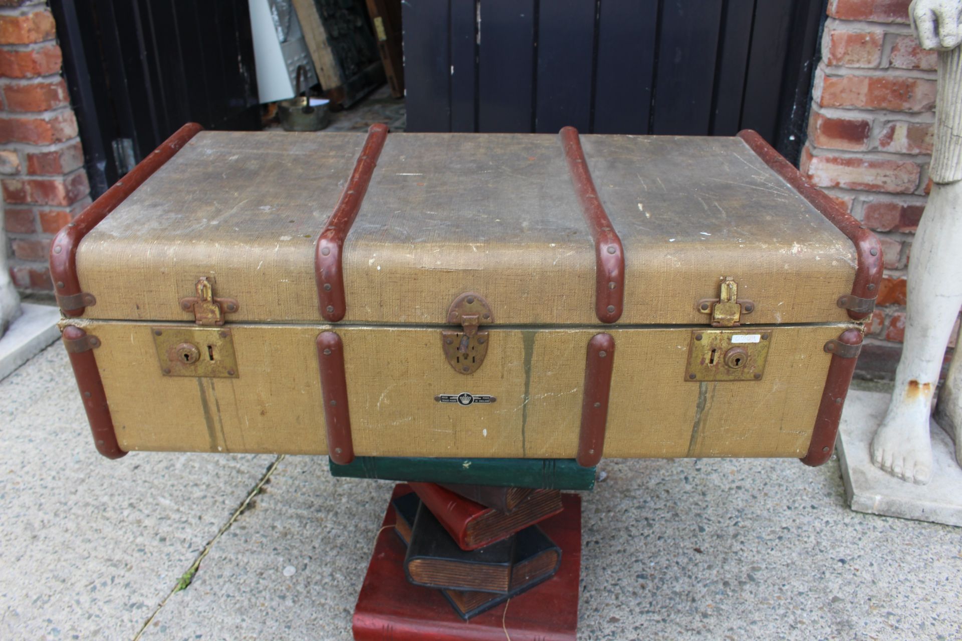 light brown leather suitcase with wooden strap