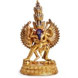 Götterfigur, wohl Tibet um 1920.Bronze, vergoldet u. partiell bunt bemalt. Auf je einem am Boden