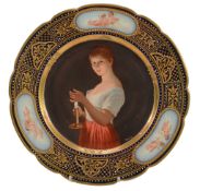 A Vienna-style plate, decorated with a maiden shielding a candle  A Vienna-style plate,