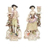 A pair of Minton porcelain figural candlesticks, mid 19th century  A pair of Minton porcelain