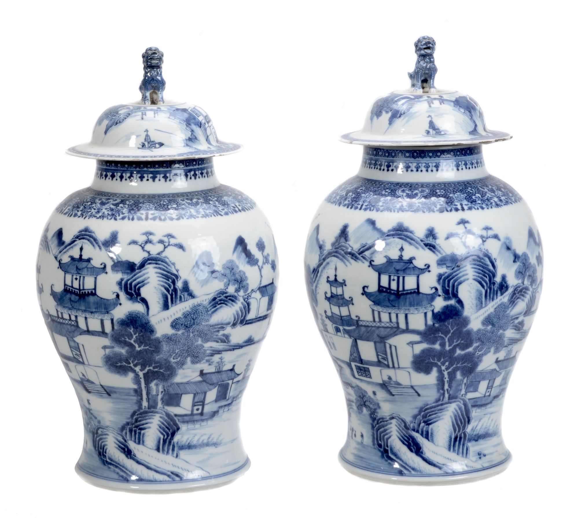 A pair of Chinese blue and white jars and covers of baluster shape decorated with lakeside scenes