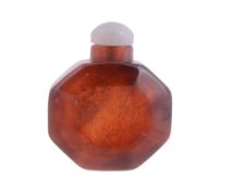 A Chinese amber snuff bottle bearing octagonal shape, 19th century  A Chinese amber snuff bottle