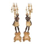 A pair of Venetian style stained and giltwood blackamoor floor standing...  A pair of Venetian style