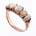 An opal ring, the five graduating opals in claw settings  An opal ring,   the five graduating