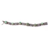 An emerald bracelet, the articulated bracelet composed of pierced and...  An emerald bracelet,   the