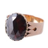 A French garnet ring , the oval faceted garnet in a closed back setting  A French garnet ring  , the