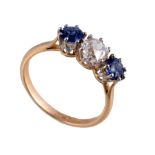 A three stone sapphire and diamond ring, the old cut diamond estimated to...  A three stone sapphire