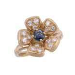 An 18 carat gold sapphire and diamond flower ring  An 18 carat gold sapphire and diamond flower