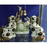 A pair of Staffordshire pottery spaniels, 25cm high and a Staffordshire figure group of a Highlander