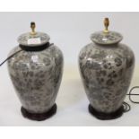 A pair of modern Oriental ceramic table lamps, grey ground with black foliate decoration, on