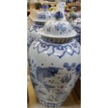 A pair of modern Chinese blue and white ceramic vases with covers, baluster shaped, fish